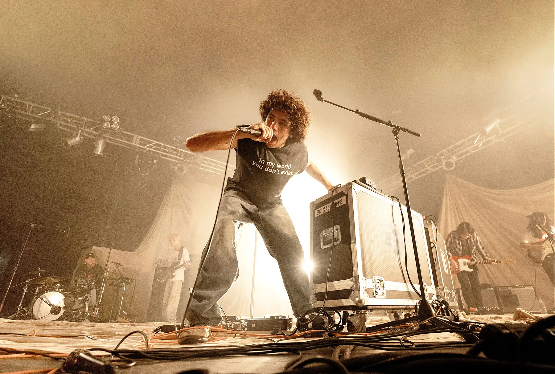 Dominic Fike performing on stage with a microphone